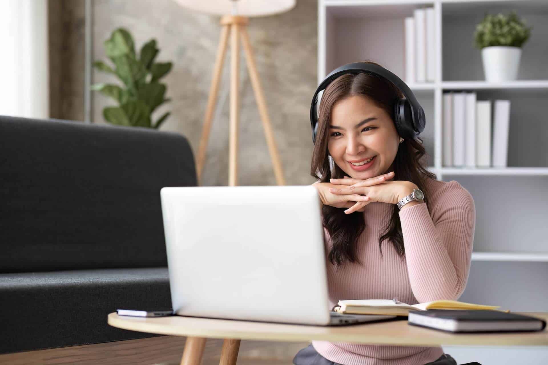 Asian Girl Watching Live Meeting on Laptop