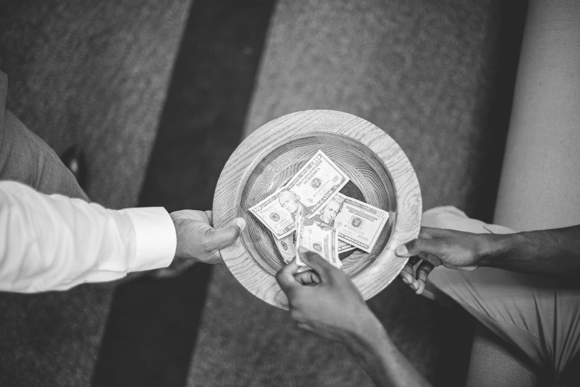 Overhead view of collection plate being passed around