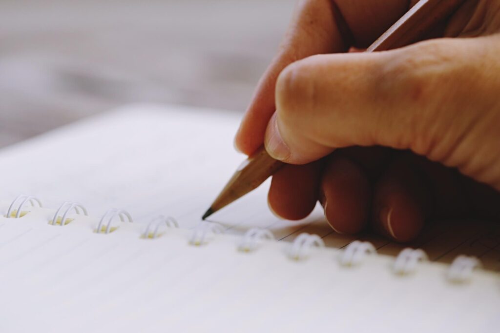 Closeup of hand writing in journal